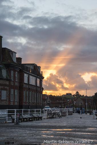 Sun shining through the clouds at Blakeney